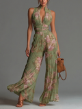 Tuta in chiffon verde a fiori con scollo a V, senza maniche, zip e pieghe a gamba larga